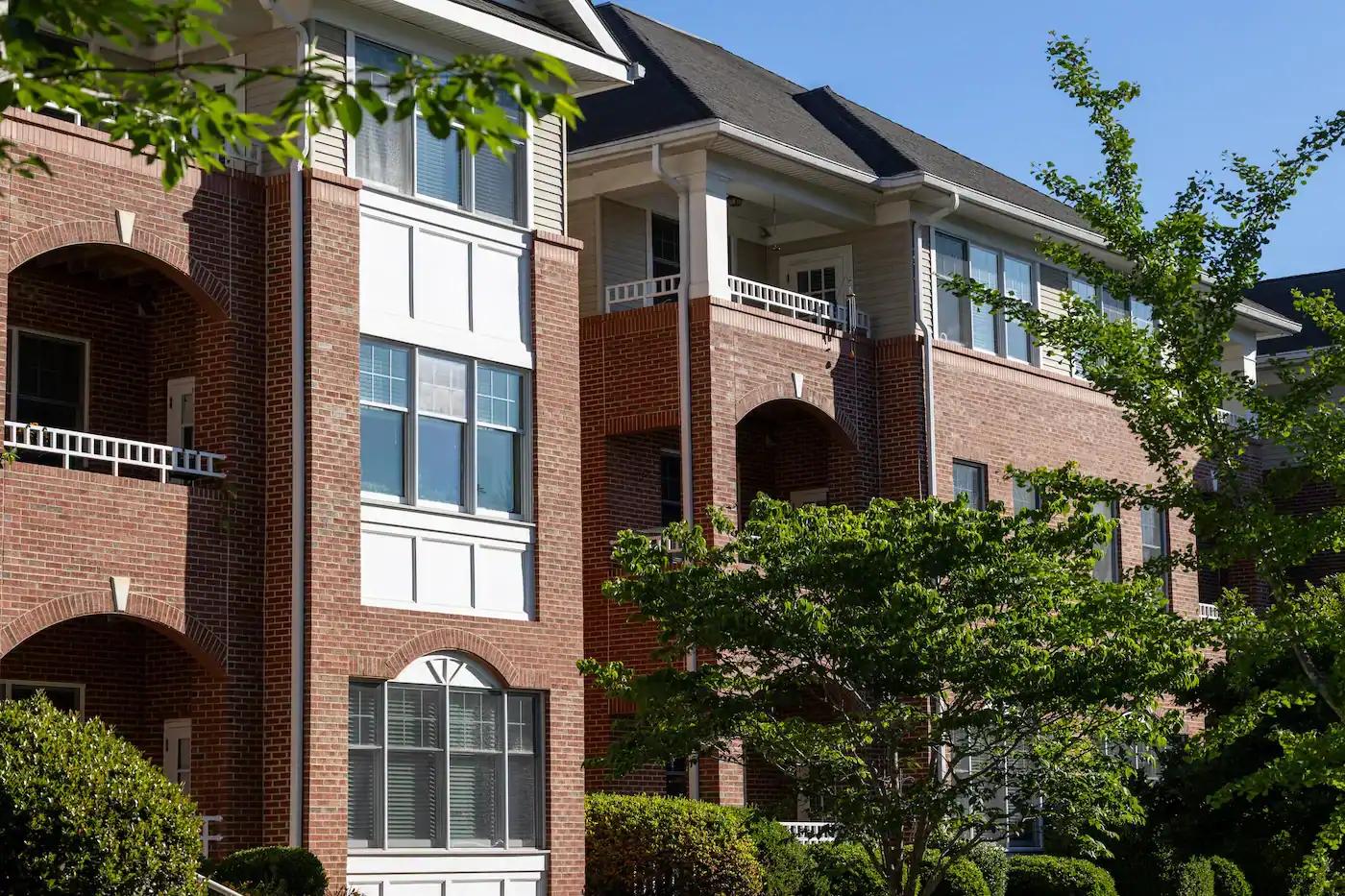 Residential apartment building at Givens Communities with lush greenery.